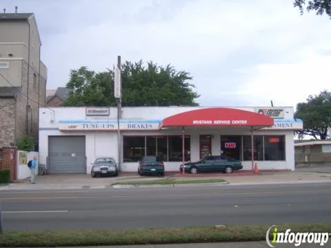 Mustang Service Center's white-brick storefront with a red awning on Live Oak Street